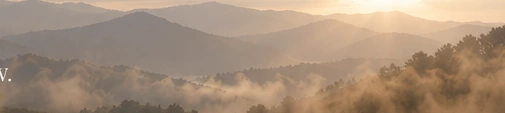 Sunrise over misty mountains